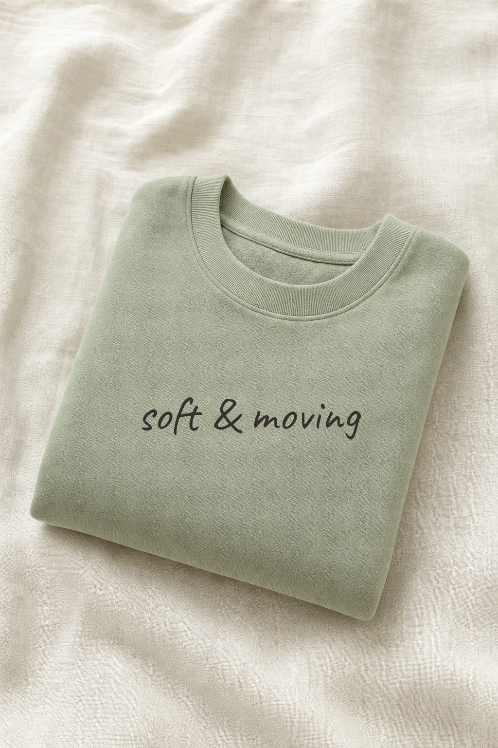 Sage green crewneck sweatshirt, folded flat lay