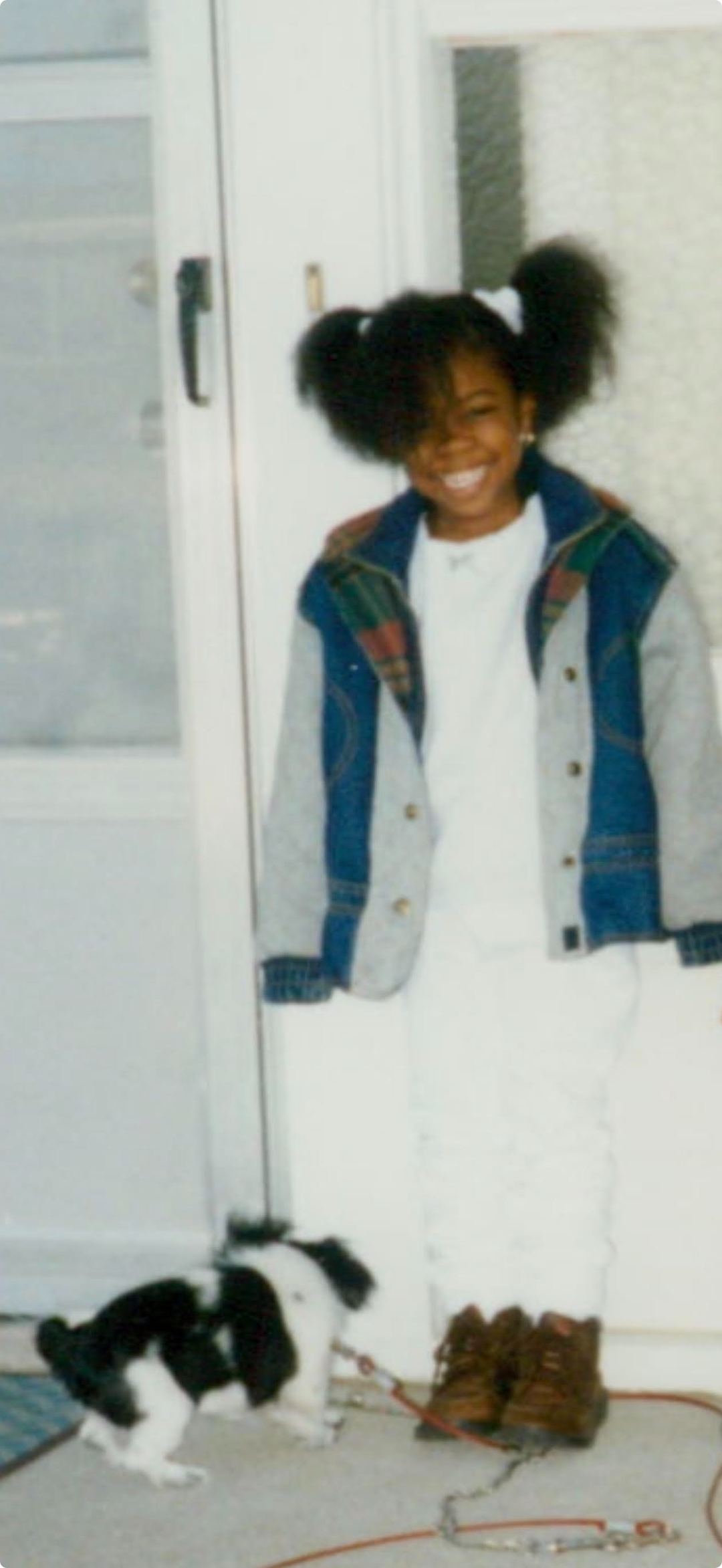 A young girl with a puppy on a porch