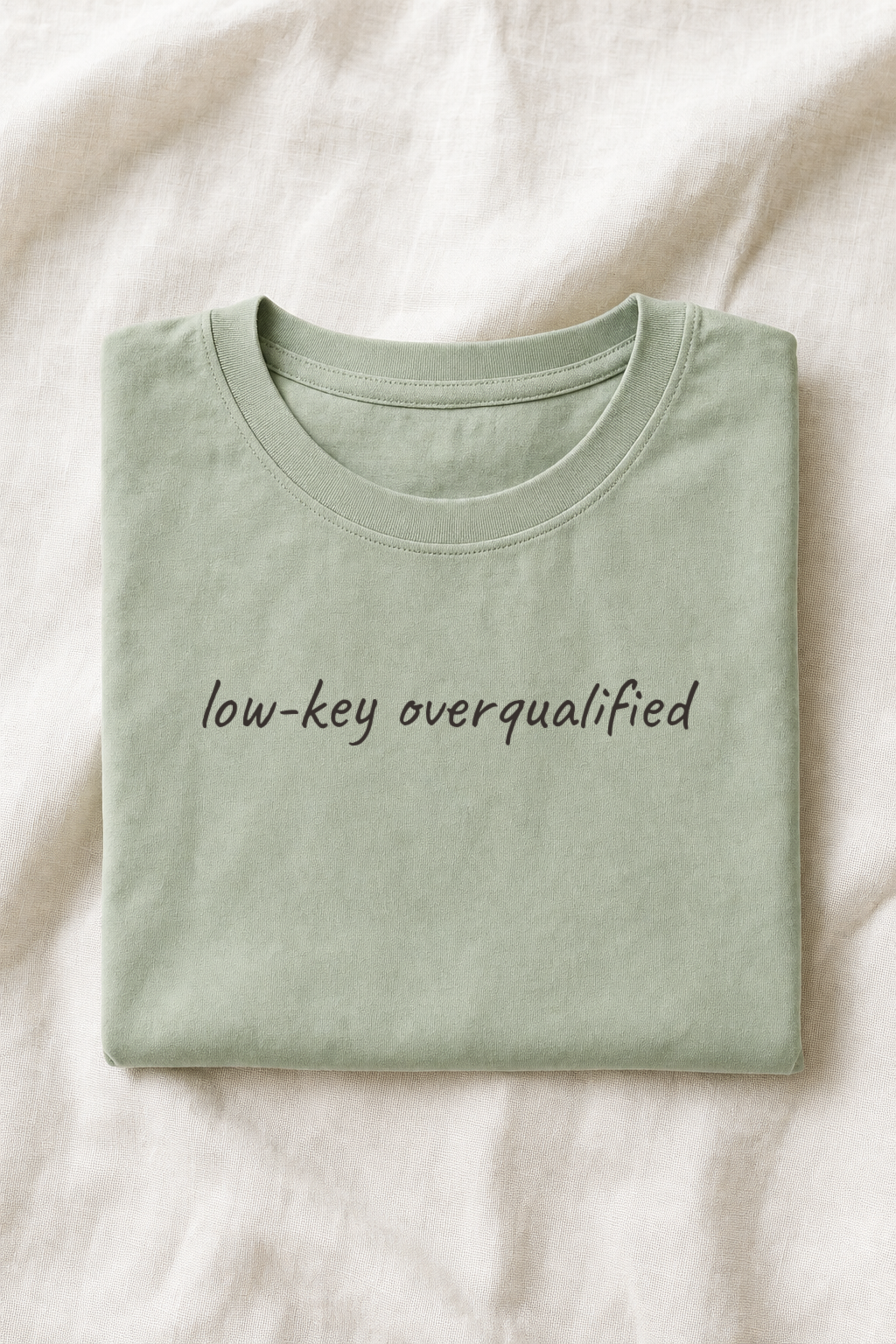 Folded sage green planner tee on ivory linen